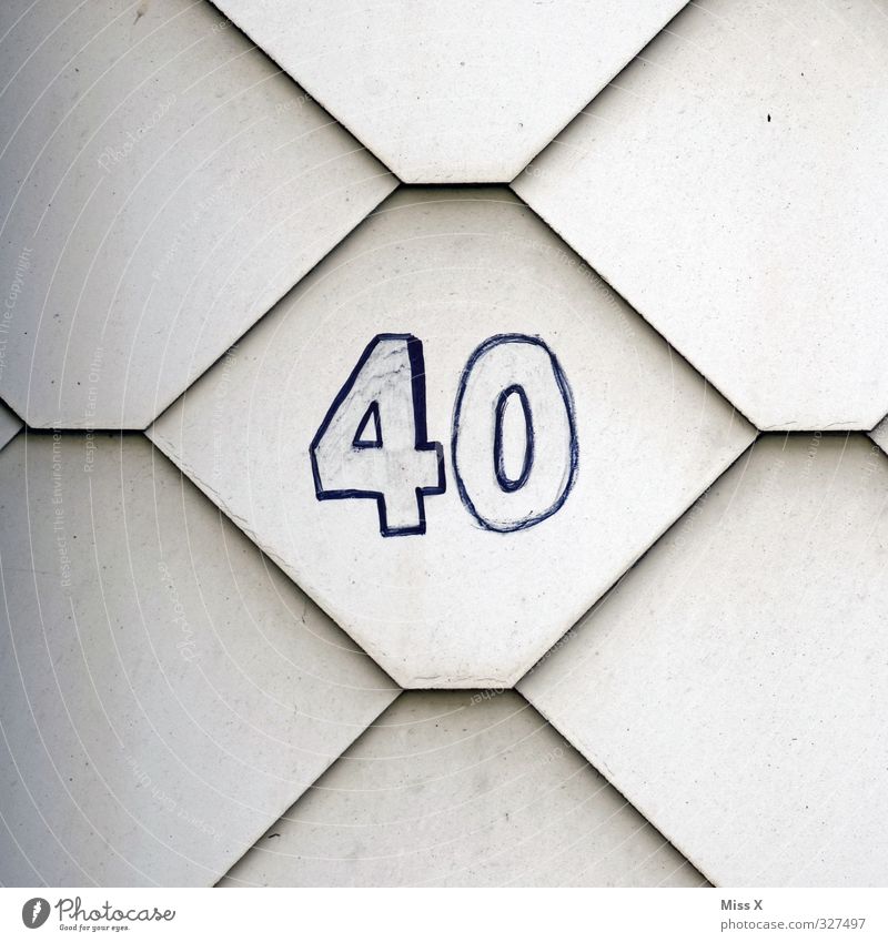 40* House (Residential Structure) 30 - 45 years Adults Wall (barrier) Wall (building) Characters Digits and numbers Old Birthday House number Colour photo
