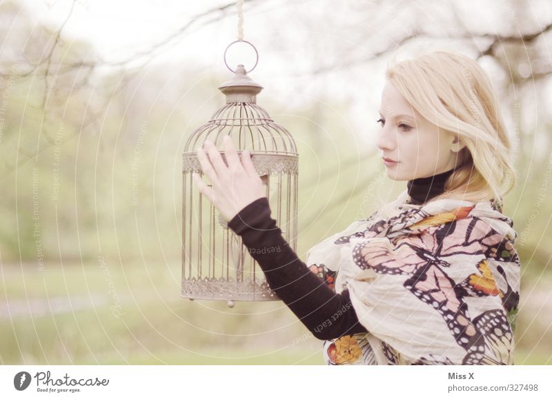 Golden cage Human being Feminine Boy (child) Woman Adults Life 1 18 - 30 years Youth (Young adults) Garden Park Blonde Pet Bird Dream Sadness Emotions Moody