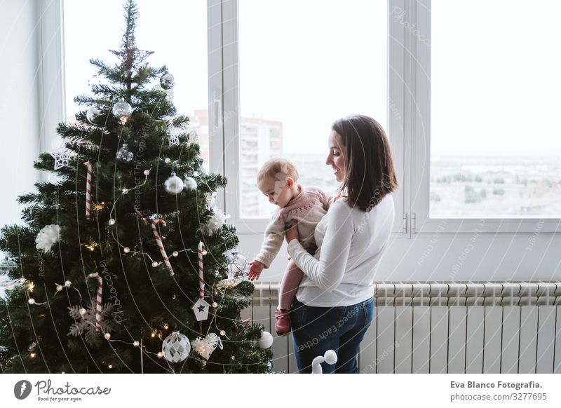 happy mother and baby girl decorating the Christmas tree Mother motherhood Happy Cute Baby Girl one year Christmas & Advent Tree Joy Family & Relations Love