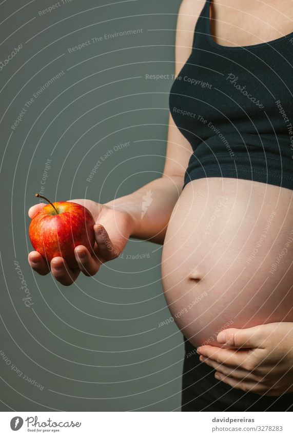 Pregnant woman holding an apple Fruit Apple Nutrition Vegetarian diet Diet Lifestyle Beautiful Baby Woman Adults Parents Mother Family & Relations Hand Love