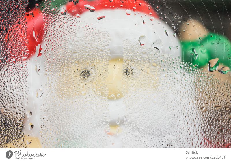 Santa Claus after work Toys Kitsch Odds and ends Plastic Looking Friendliness Happiness Determination Effort Glass Window pane Condensation Water Drop Misted up