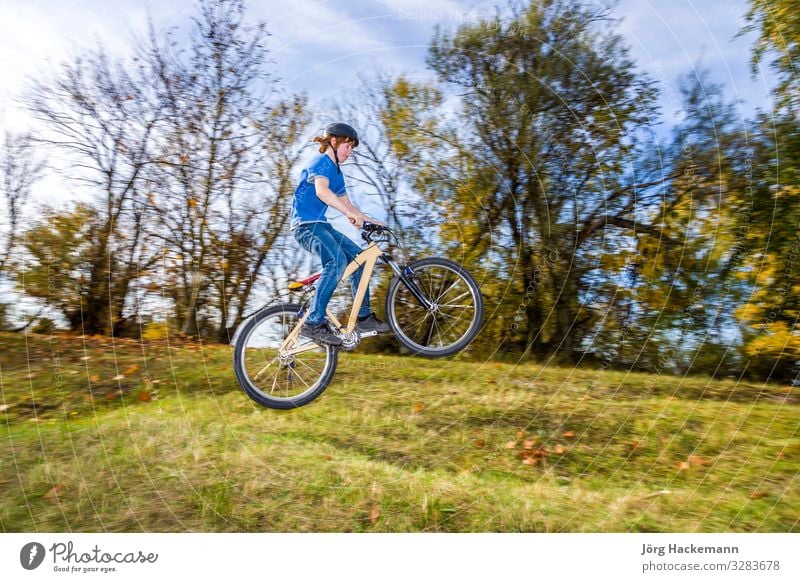 boy jumps over a ramp with his dirt bike Joy Happy Summer Boy (child) Youth (Young adults) Nature Fitness Jump BMX bike Bike Training airborne athletic bicycle