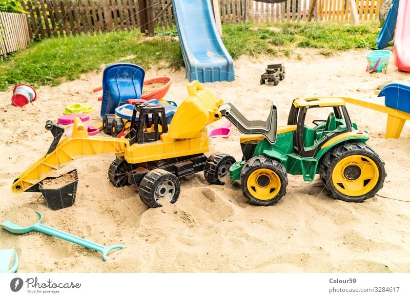 Colourful toys in the sandbox Joy Playing Children's game Summer Beach Kindergarten Nature Sand Toys Plastic Positive Yellow Green Background picture Excavator