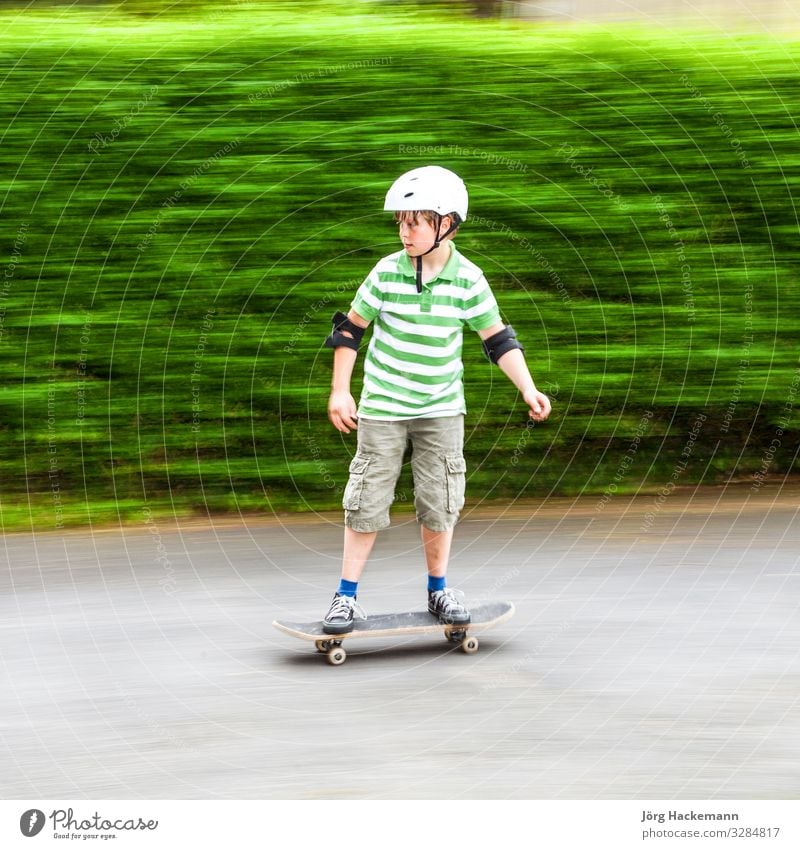 boy skating with speed Joy Leisure and hobbies Sports Boy (child) Nature Park Transport Vehicle Clothing Toys Speed White Safety Protection Roller Skateboard