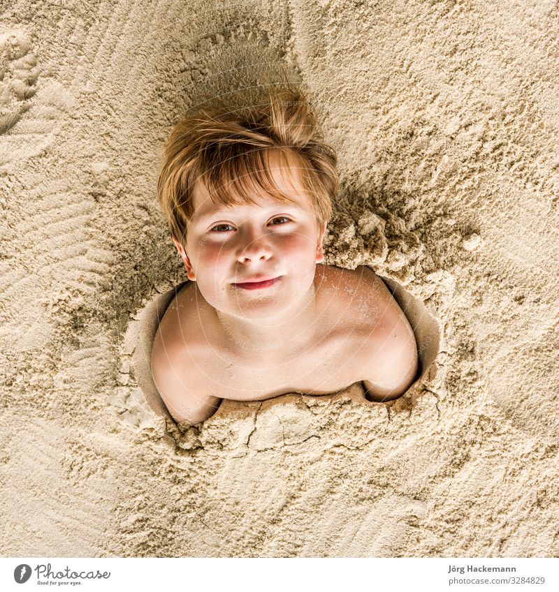 Happy Young Boy Covered By Fine Sand A Royalty Free Stock Photo From Photocase