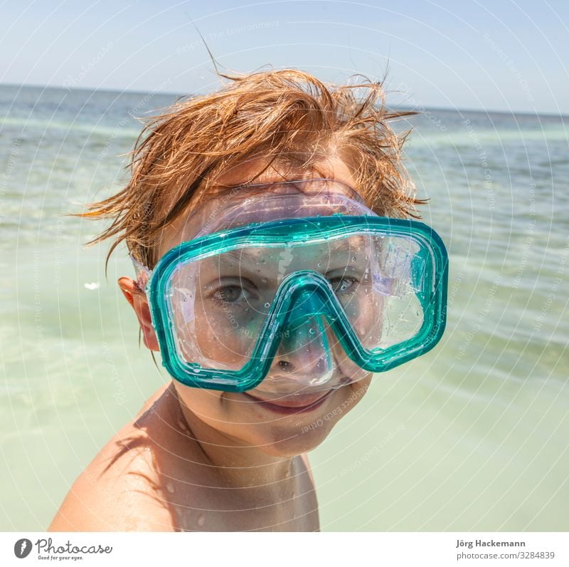boy with diving mask enjoys the ocean Joy Happy Beautiful Body Skin Face Relaxation Leisure and hobbies Vacation & Travel Sun Ocean Waves Dive Child Boy (child)