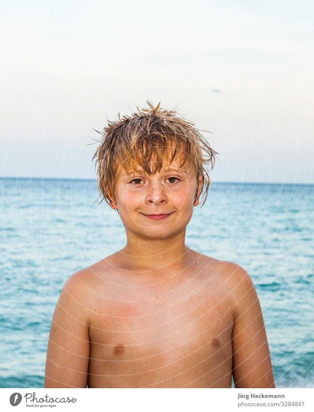 portrait of cute smiling boy at the beach under blue sky Joy Happy Beautiful Body Skin Face Relaxation Leisure and hobbies Vacation & Travel Sun Ocean Waves