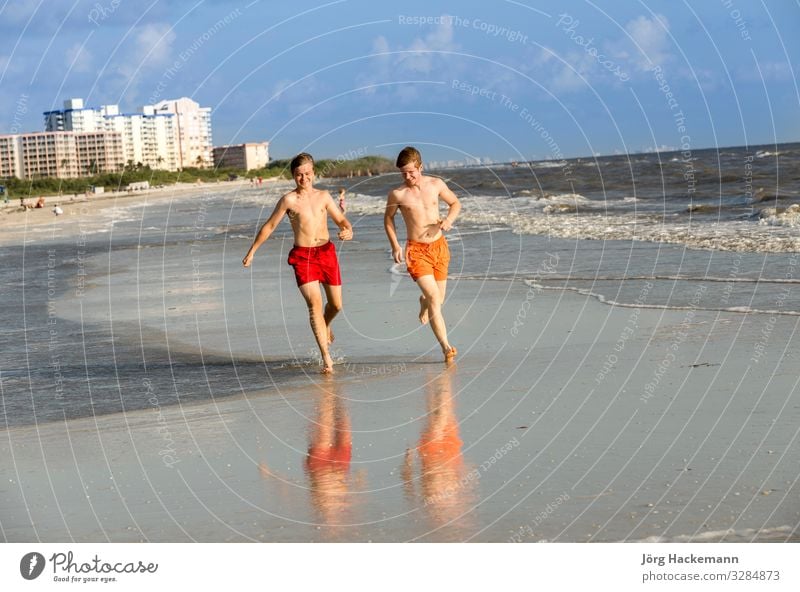 teenager enjoys jogging along the beach Joy Happy Body Relaxation Vacation & Travel Beach Jogging Boy (child) Youth (Young adults) Sand Movement Fitness