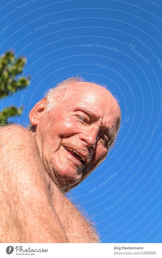 senior sits in the chair in the garden Lifestyle Joy Happy Relaxation Summer Sun Garden Retirement Man Adults Grandfather Nature Sky Old Smiling Blue Green