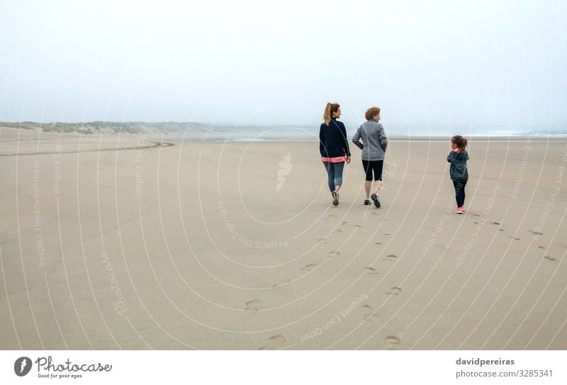 Three generations female walking on the beach Lifestyle Beach Child Human being Woman Adults Mother Grandmother Family & Relations Sand Sky Autumn Fog Footprint