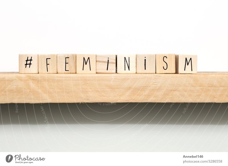 Wooden cubes with a hashtag and the word Feminism School Woman Adults Media Book Paper Black White Idea Emancipation education Definition letter learn knowledge