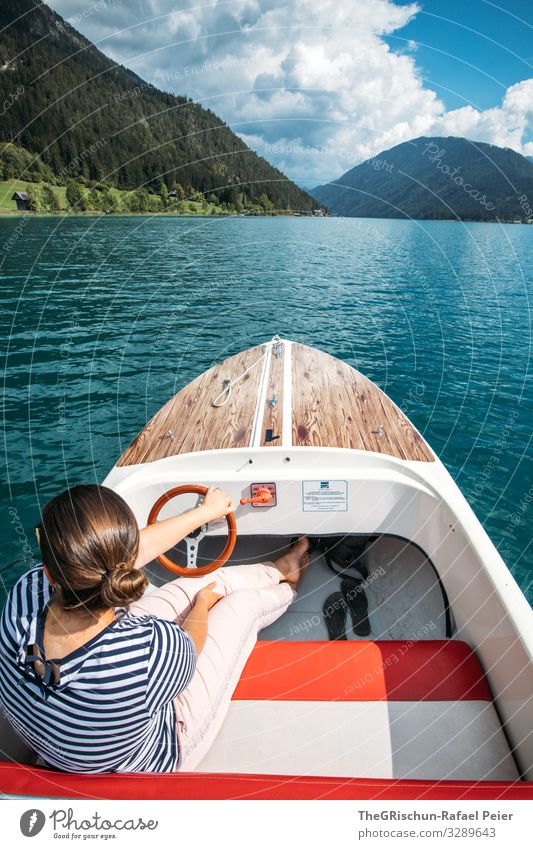 Woman on boat on lake Nature Blue Black Turquoise White Boating trip Watercraft Lake Vantage point Hill captain Captain Steering Travel photography To enjoy