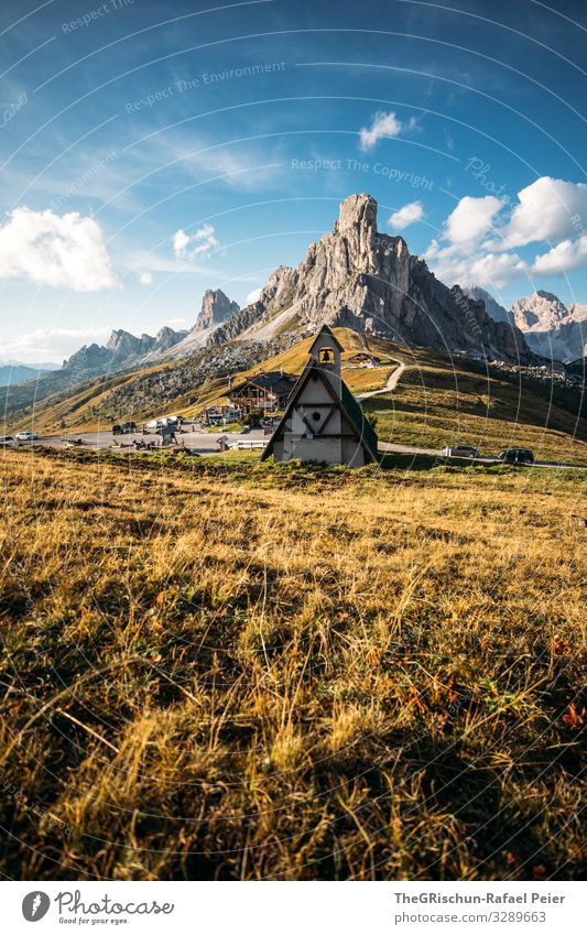 Church on the Passo di Giau South Tyrol Mountain Clouds Landscape Light mountains Evening Sun Nature Blue Grass Sky Meadow Exterior shot Street pass road Green