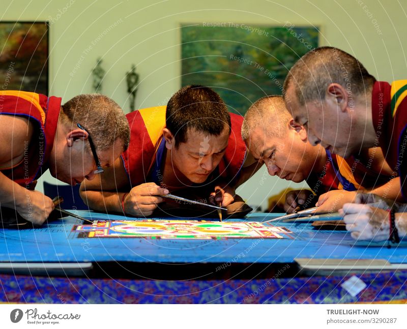 Tibetan monks of the exile monastery Sera-Jey during the ritual design of a sand mandala after an old pattern with coloured grains of sand Lifestyle Design