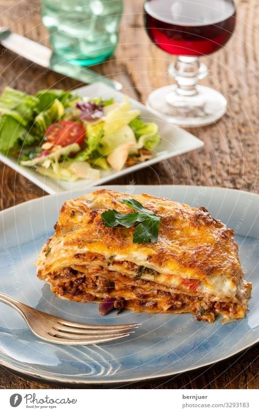 Lasagne on a plate Meat Cheese Vegetable Nutrition Dinner Crockery Fork Gastronomy Wood Fresh Delicious Parsley pasta Tasty disk Carbohydrates Bolognaise