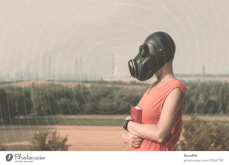 young girl in a gas mask in a red dress with a book Body Factory Industry Human being Woman Adults Hand Book Environment Nature Landscape Plant Horizon Tree
