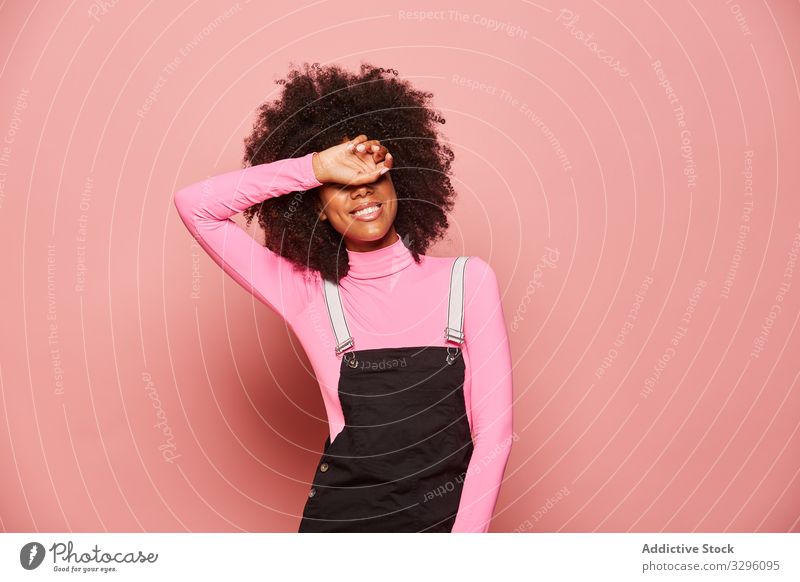 Young African American woman covering eyes with hand smile surprise waiting excited happy pink laugh cheerful shy timid shame shyness embarrassed