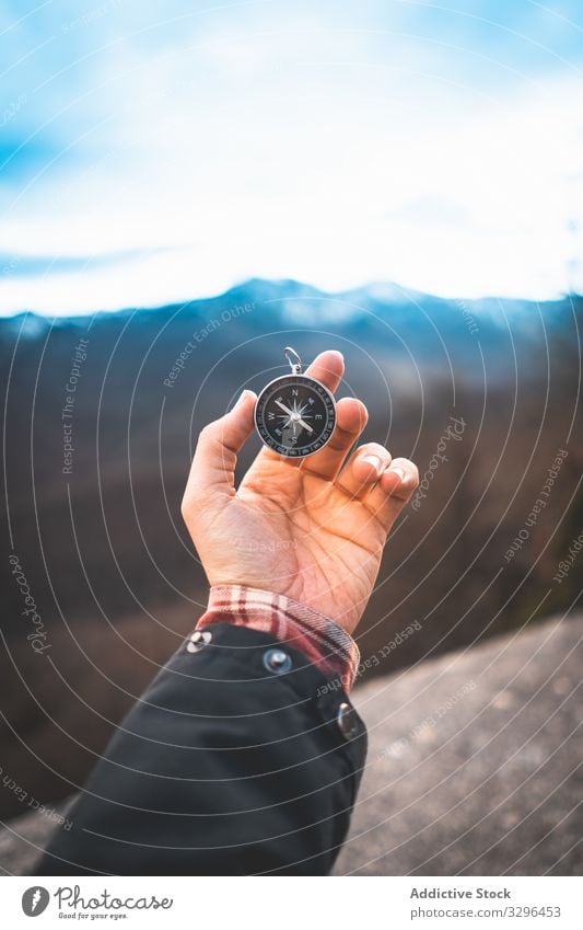 Traveler holding compass in hand in mountains traveler direction rock navigation geography orientation research sign exploration expedition tourism tool