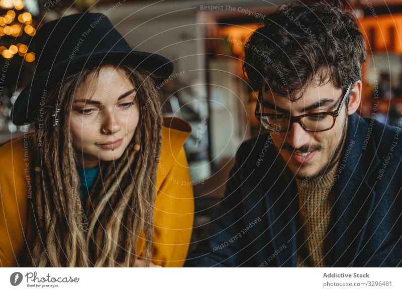 Stylish woman and man working on laptop in cafe people stylish student typing analyzing friendship casual start up content freelancer creative occupation device
