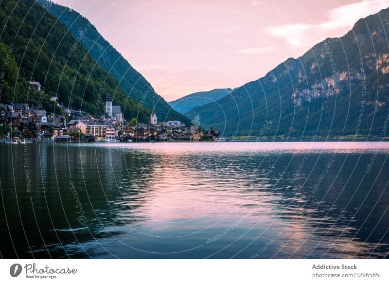 Calm lake and town near mountains calm shore cloudy daytime landscape water austria scenic house architecture exterior structure construction cottage coast