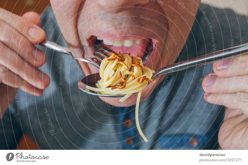 Man eating spaghetti with worms Nutrition Eating Lunch Dinner Diet Fork Spoon Lifestyle Exotic Human being Adults Worm Authentic Disgust Delicious