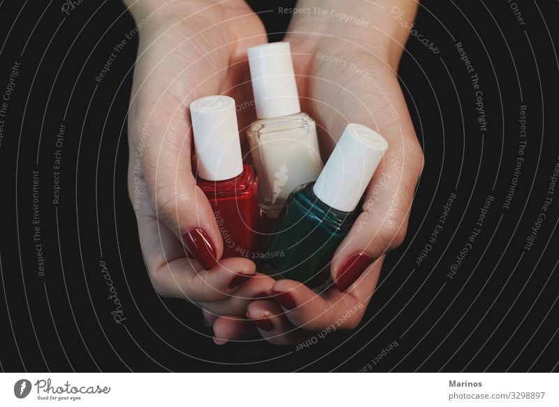 Polish bottles in woman hands. Bottle Beautiful Manicure Medical treatment Spa Human being Woman Adults Hand Fingers Red Colour nail care salon trimming