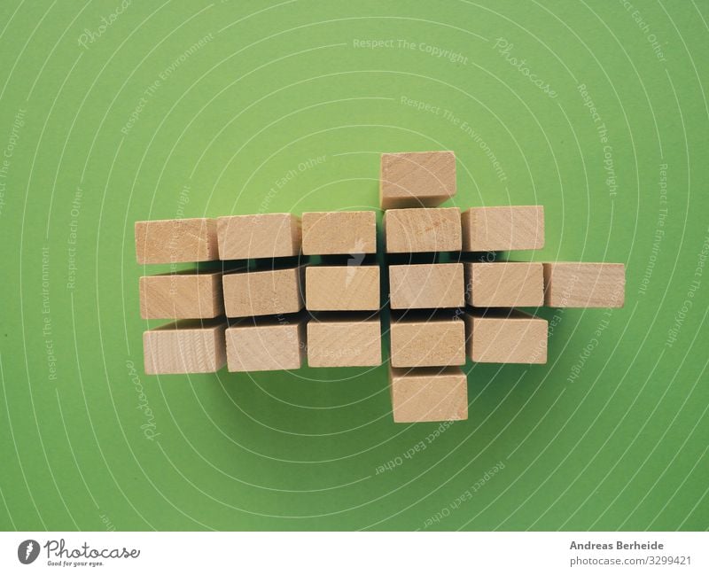 Arrow shape with wooden blocks on green Business Retro Success Advancement Target strategy Plan process structure Image (representation) simplicity color
