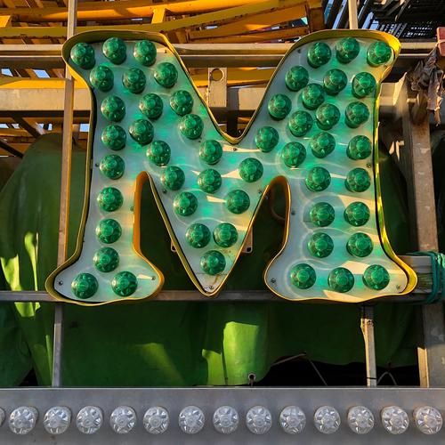 m Characters M Green Colour Joy Idea Communicate Creativity Joie de vivre (Vitality) Fairs & Carnivals Electric bulb Latin alphabet Colour photo Exterior shot