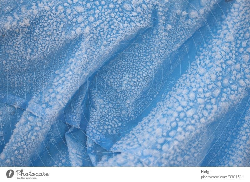 ice age | blue plastic tarpaulin with folds is covered with hoarfrost Ice Frost Packing film Folds Plastic To hold on Freeze Authentic Exceptional Cold Blue