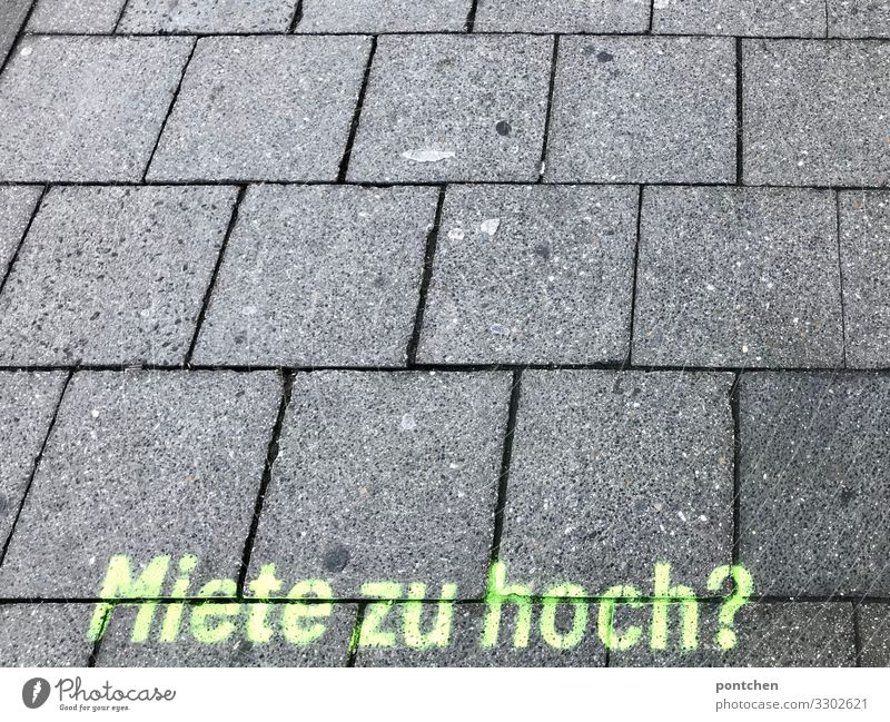 Imprint ask rent too high on cobblestones. Rent profiteering. real estate industry Munich Change Lanes & trails Target Future Paving stone Graffiti