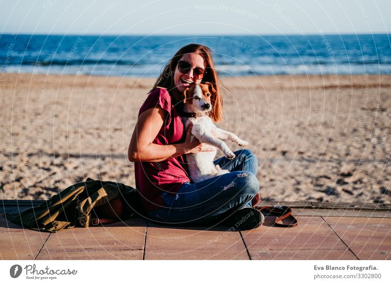 happy woman and her cute cute sitting at the beach Woman Dog Jack Russell terrier Love Beach Sunset Together White Leisure and hobbies Beautiful Lifestyle
