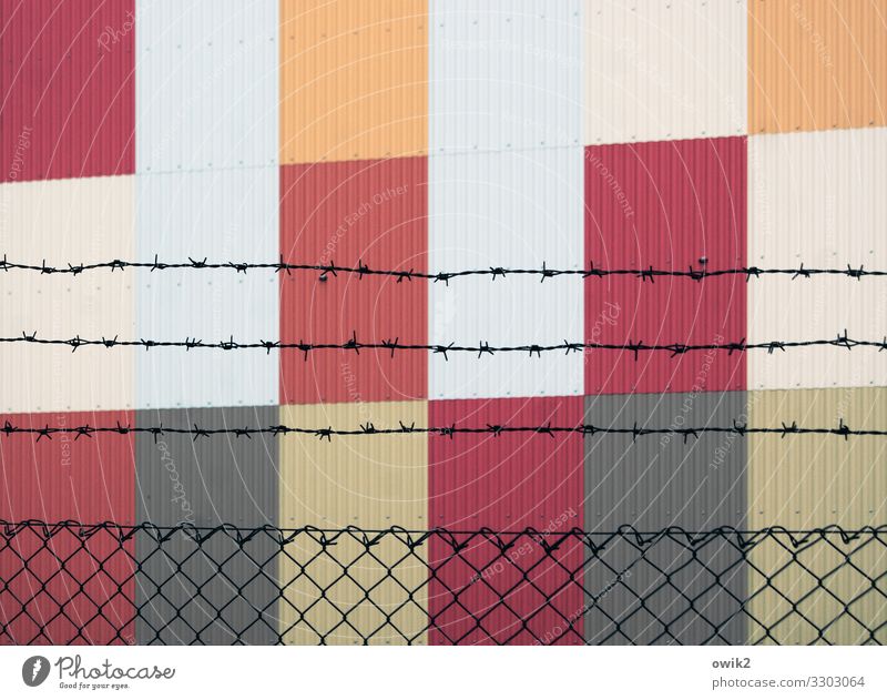 Cultural outcasts Art Wall (barrier) Wall (building) Facade Barbed wire fence Fence Wire netting Metal Sharp-edged Simple Modern Point Thorny Gray Orange Red