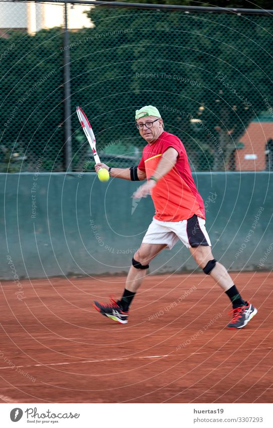 A middle-aged man plays tennis Lifestyle Playing Sports Human being Masculine Man Adults 1 45 - 60 years Old Competition Racket ball Tennis fitness court Player