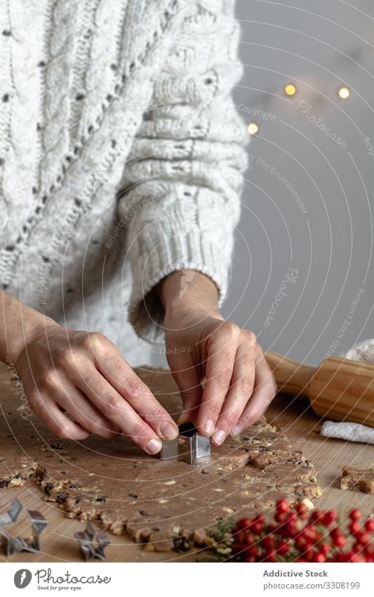 Anonymous lady preparing cookies with tin form for baking cooking using woman kitchen rolling pin dough process shape star festive pastry preparation food arms