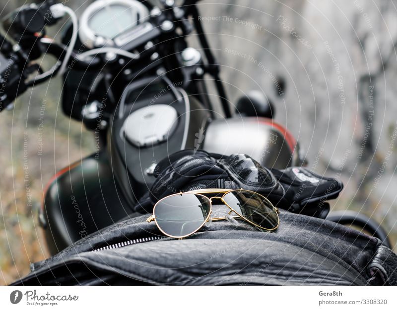 sunglasses and gloves on the motorcycle fuel tank Style Transport Motorcycle Fashion Clothing Leather Accessory Sunglasses Gloves Glass Metal Brown