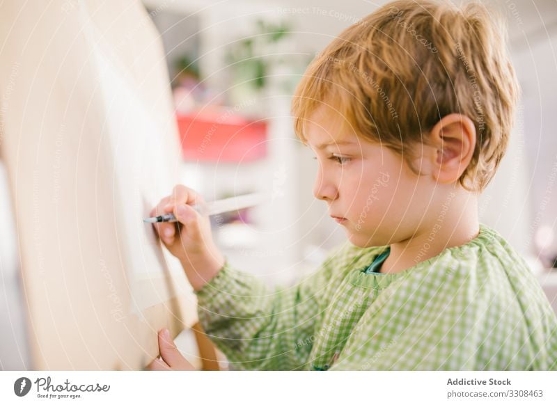 Kid drawing on canvas at home child picture kid boy art serious calm paint hobby peaceful casual house childhood apartment flat creative free time relax day