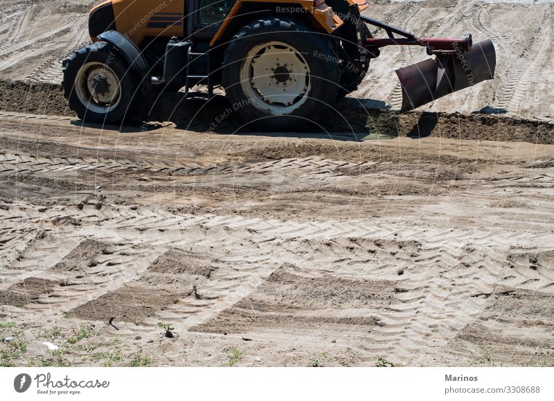 Tractor preparing land. Industry Nature Landscape Sand Street Animal tracks Brown Tire Tread Farm background Ground Consistency field Plowed trace spring glass