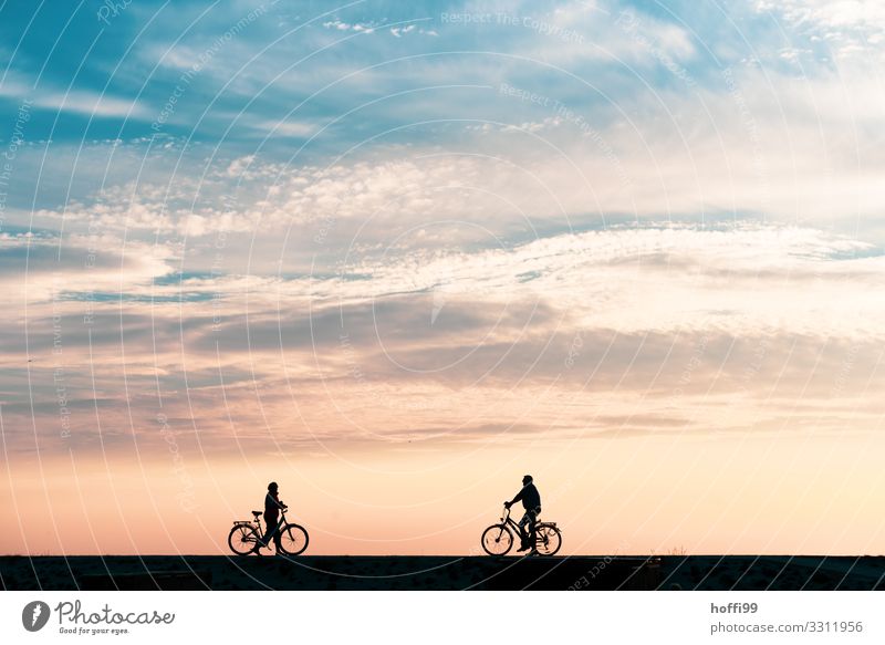 Silhouette of two cyclists meeting on a dike on Baltrum at sunset Beach Cycling Human being Couple Adults 2 Nature Landscape Sunrise Sunset Beautiful weather