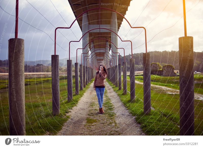 Young woman hiking on the countryside, below a bridge Winter Human being Feminine Youth (Young adults) Woman Adults 1 18 - 30 years Landscape Bridge Building