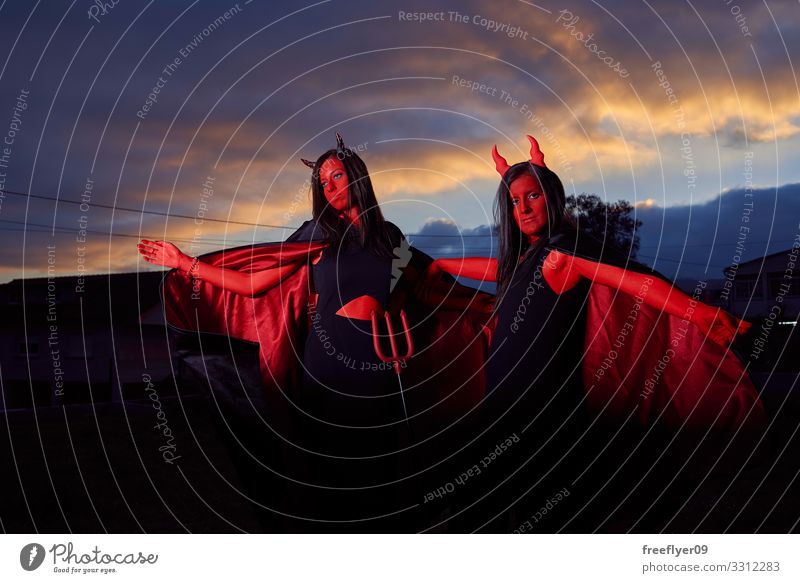 Two young women in devils costumes at halloween Style Leisure and hobbies Playing Hallowe'en Young woman Youth (Young adults) Woman Adults 2 Human being