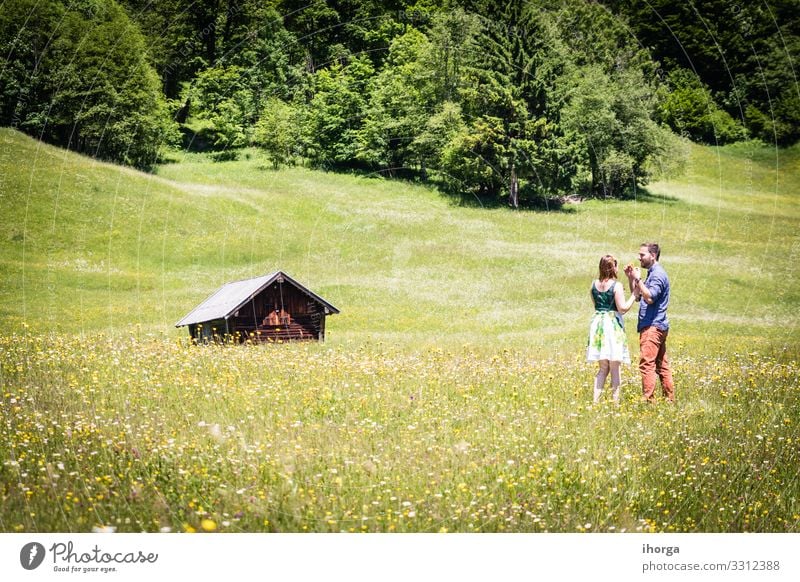 happy lovers on Holiday in the alps mountains adventure background beautiful cheerful countryside couple europe female field flower forest girl green hands