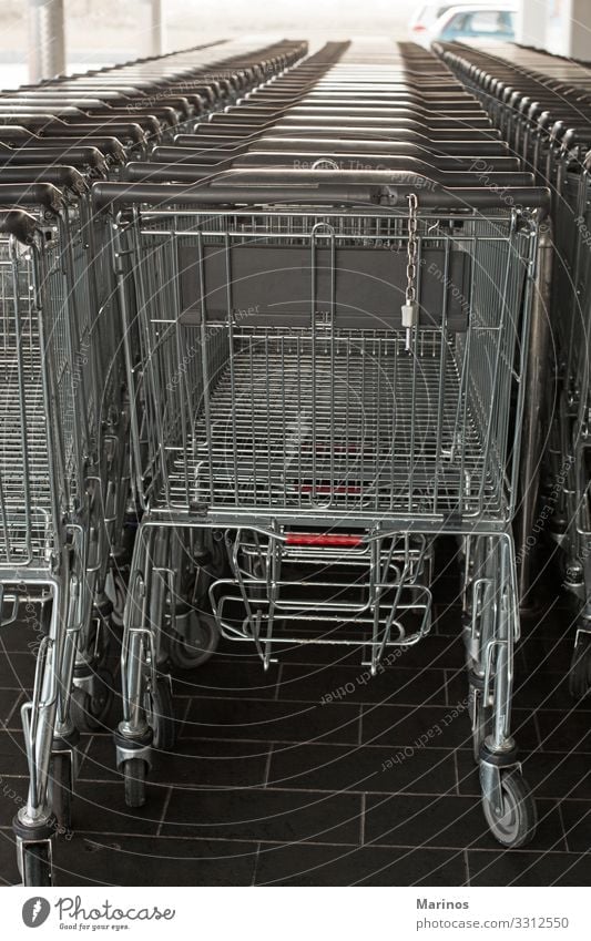 Shopping carts in a supermarket. Food Business Line Supermarket Retail sector Storage row background buy empty trolley consumer aisle Consumption Hypermarket