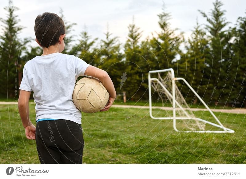 kid holding a soccer ball on garden field. Lifestyle Joy Happy Playing Sports Soccer Child Human being Boy (child) Man Adults Grass Happiness Green football