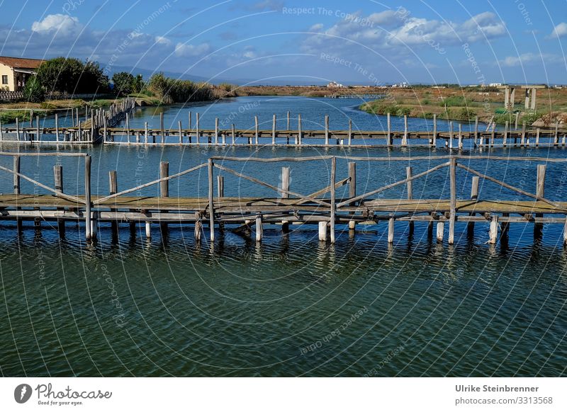 Lagoon lake with fishing device in Cabras Lake Stagno di Cabras Mullet fishing Channel Sardinia Fish Stoppages Landscape Italy Vacation & Travel Water Tourism