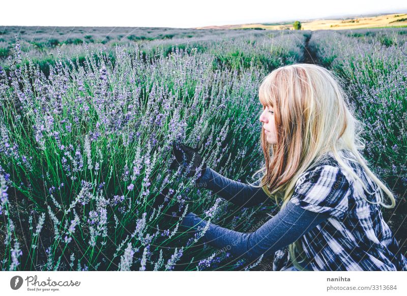 Young blonde woman alone in a lavender field young nature life garden gardening parfum spring springtime flowers lovely freedom candid real real woman summer