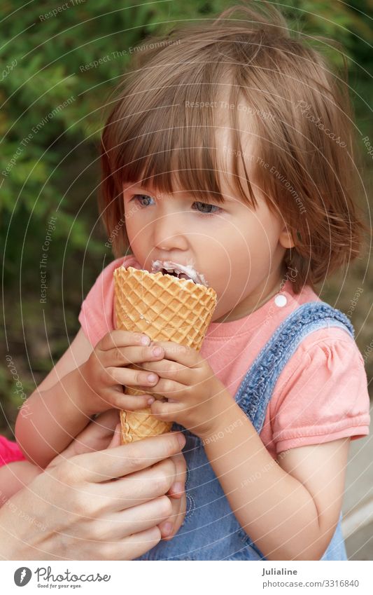 Cute girl are eating icecream Ice cream Eating Child Baby Woman Adults Park Blonde White kid European Caucasian one two three Lady short hair Horizontal
