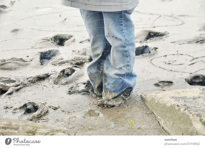 muddy Child Infancy Legs feet Jeans Mud Beach Coast Mud flats Walk along the tideland Slick Minerals Salt Healthy Wellness Ocean Tide North Sea Low tide
