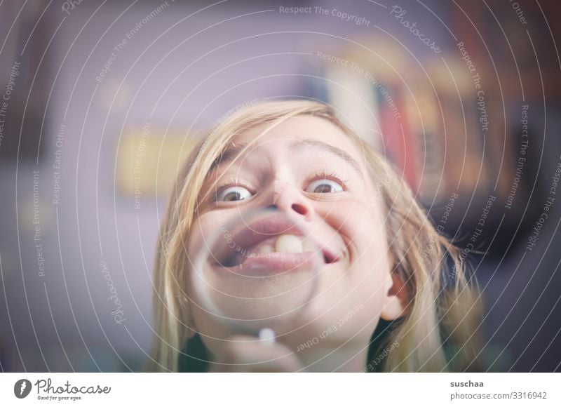 a case for the orthodontist Child Girl Head Face Grimace Funny Looking Distorted Magnifying glass Enlarged Joy Detail Crazy Funster Absurdity Excitement
