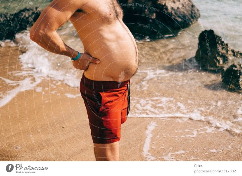 A man with a big belly in swimming trunks on the beach Masculine Man Adults Stomach 18 - 30 years Youth (Young adults) 30 - 45 years Round Pregnant