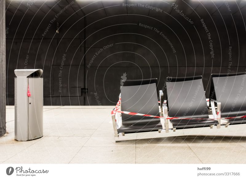 Trash can and defective bench with fluttering belt in subway station Underground Wall (barrier) Wall (building) Bench Trash container Barrier Build Sit Wait
